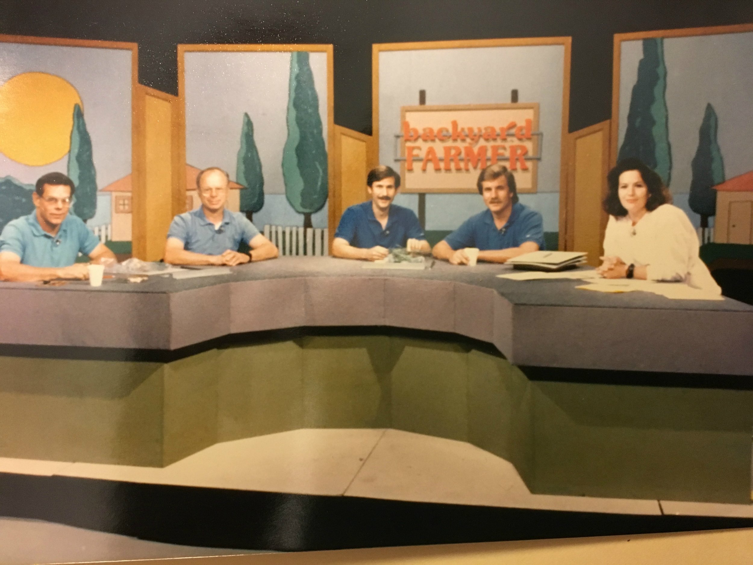 The cast and set of Backyard Farmer, sometime in the late 1980s. From left to right are the respected scientists who answered viewers' questions; a plant pathologist, a horticulturalist, an entomologist and another plant pathologist. I'm the one with what I'm sure I thought was some kind of anchor-girl hair, a pink sweatshirt and a big black plastic watch. What was I thinking? (Credit: NET)