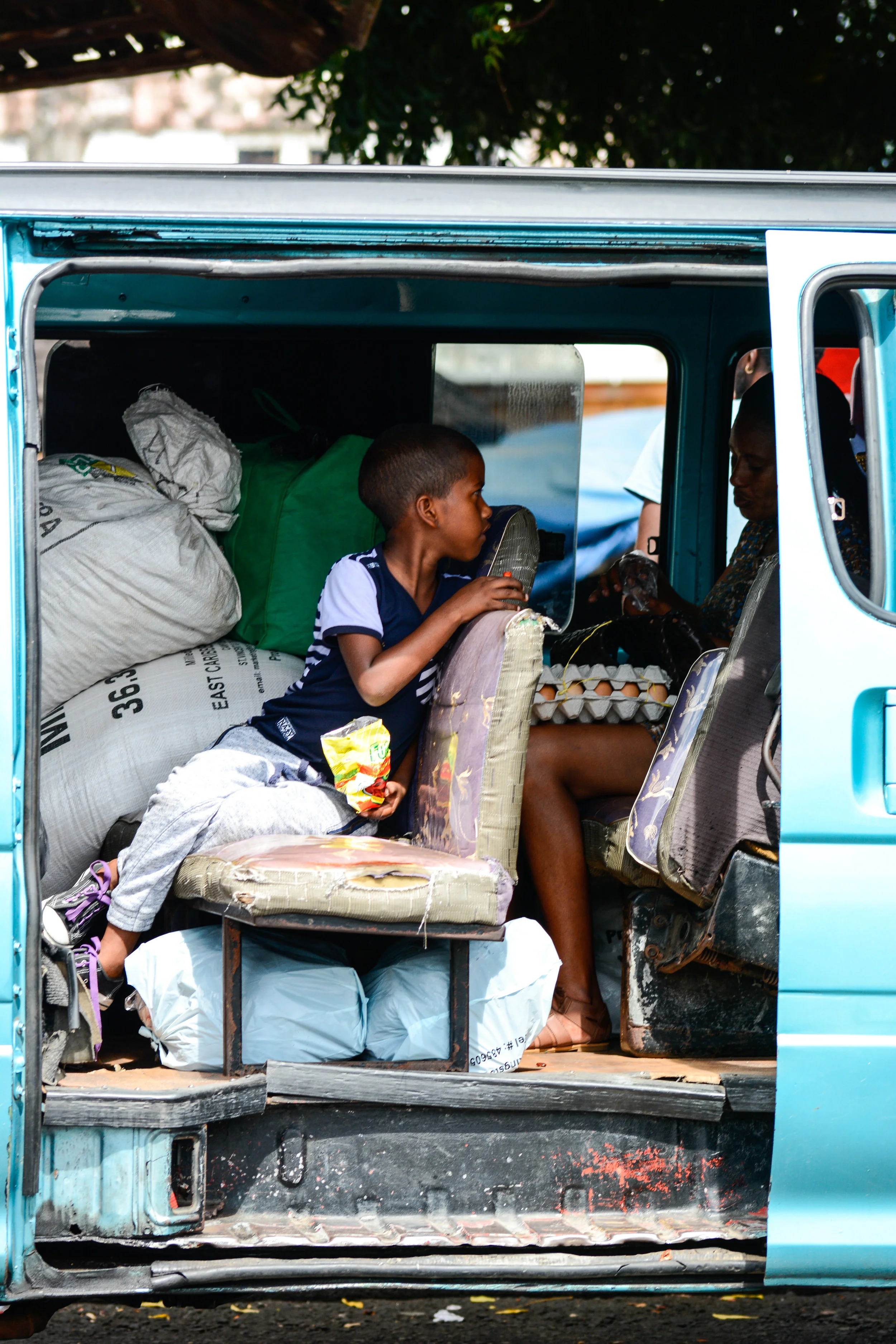 You can tell when the vans are headed to the country side because the passengers load up with heavy cargo as they make their weekly trips into town. Many of these people have to carry their flour sacks full of food up mountain paths to their homes.