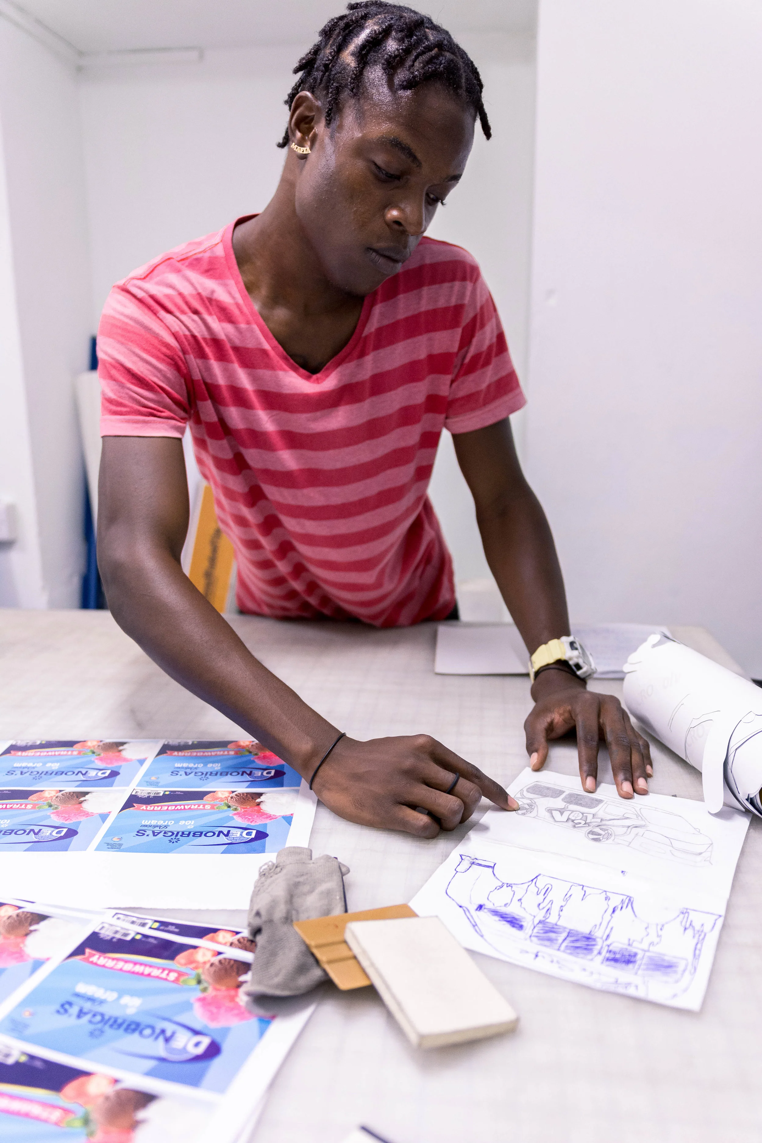 One of the employees at the studio is Trey. You can find Trey working all different types of jobs, from printing to carefully applying the vinyl. But where he prefers to be found is dreaming of making his own van art, he shared with me some of his designs that he makes in his spare time in hopes that one day he could see his art on the road. His eyes beamed with pride thinking that one day he would be able to see his art on the streets of St.Vincent covering a van.