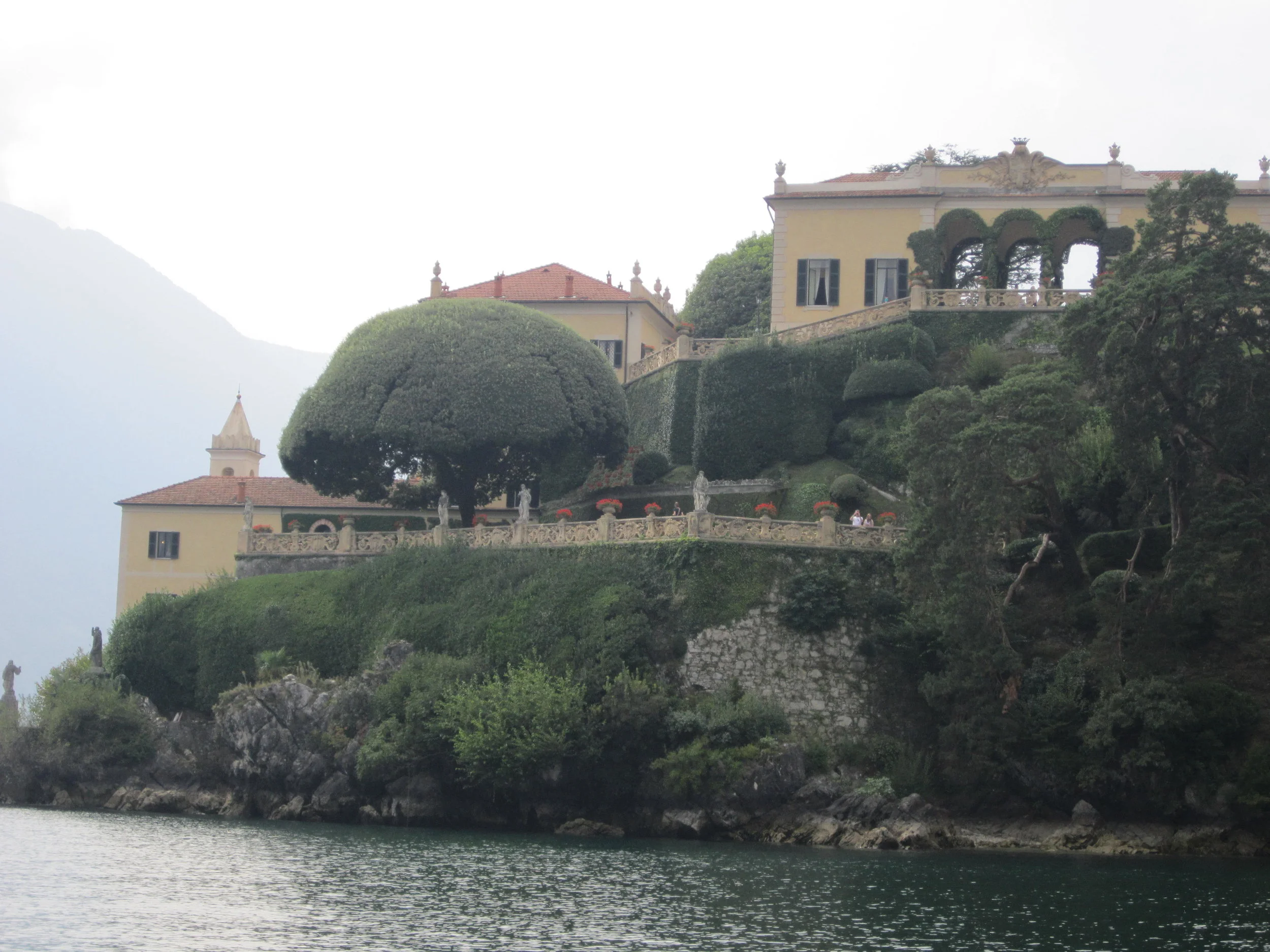 Villa del Balbianello as seen from the lake. The three arches of the loggia, which are flanked by the map room and the library, lie at the top right of the photo. Both loggia rooms, as well as the interior of the villa, can be seen on a guided tour of the property.