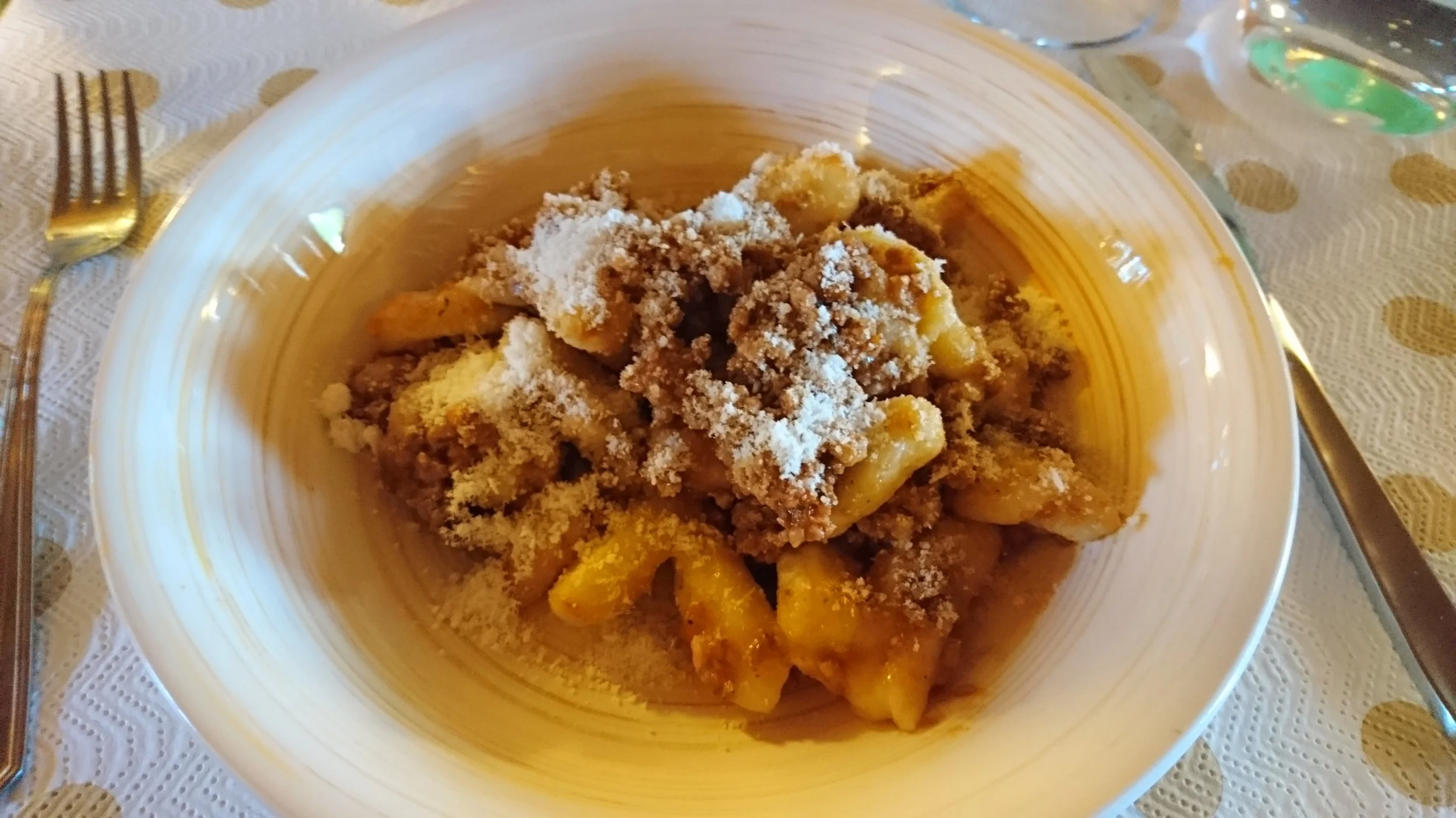 Finished gnocchi topped with ragu.