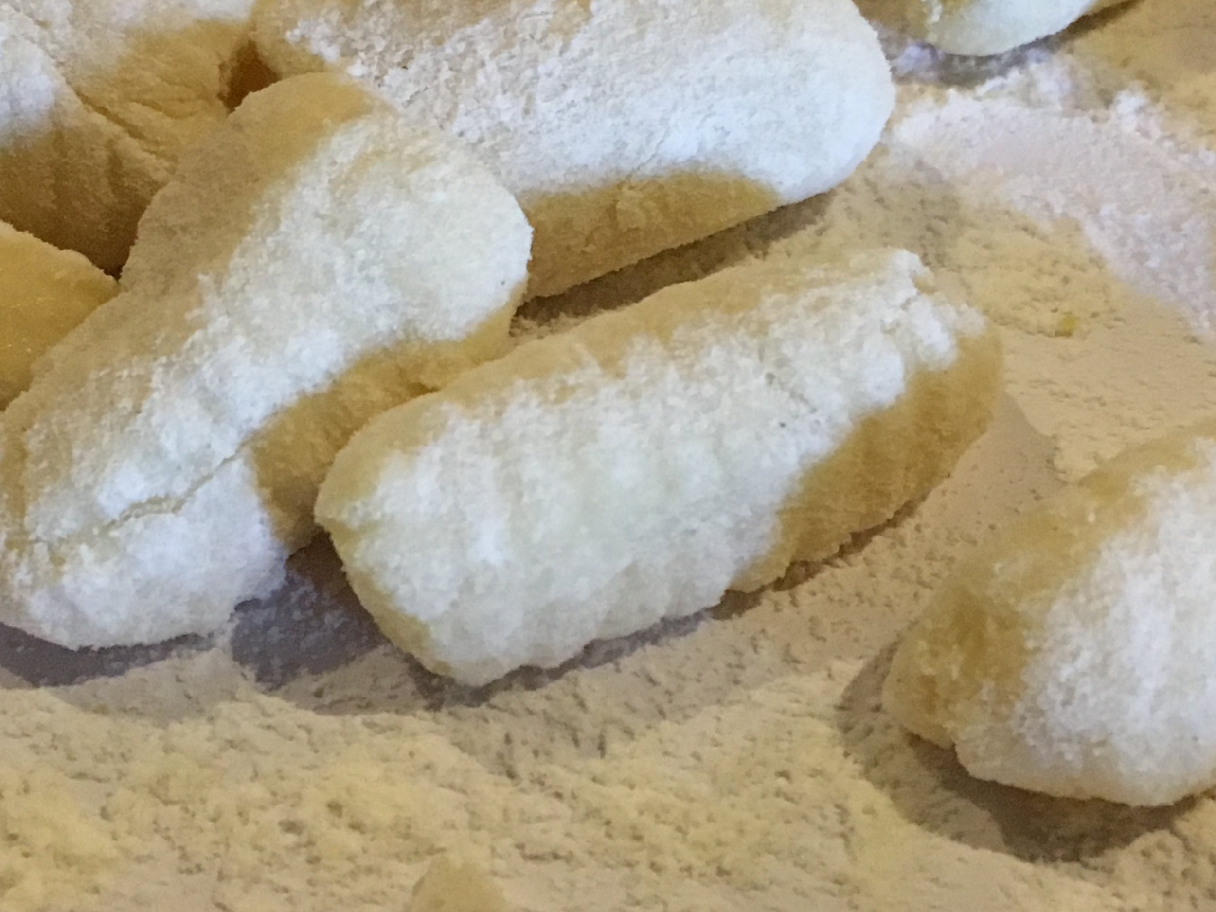 Finished gnocchi, dusted with flour and ready for immersion in boiling water.