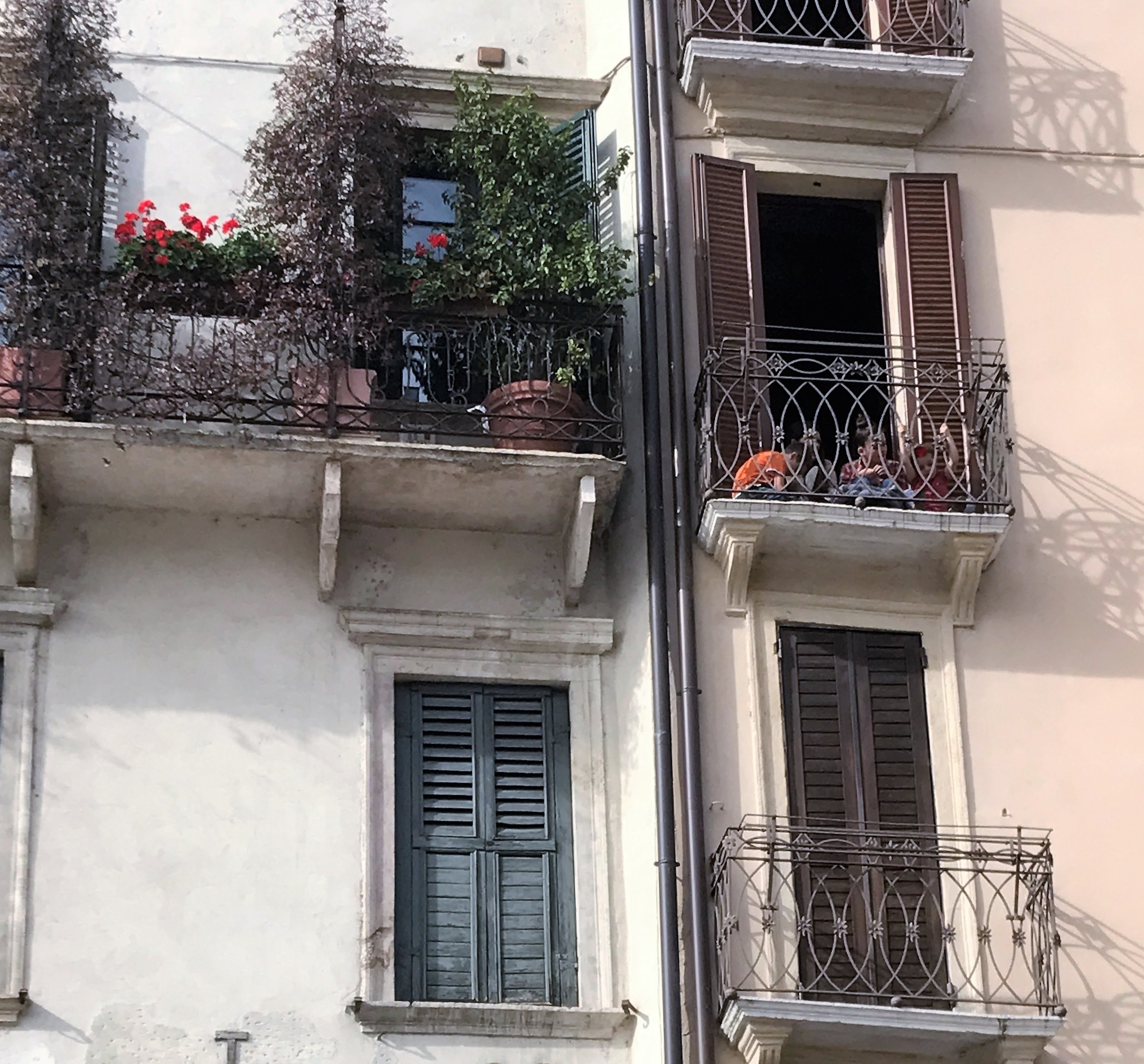 Children in Verona have an enviable view from a small balcony that overlooks Piazza delle Erbe.