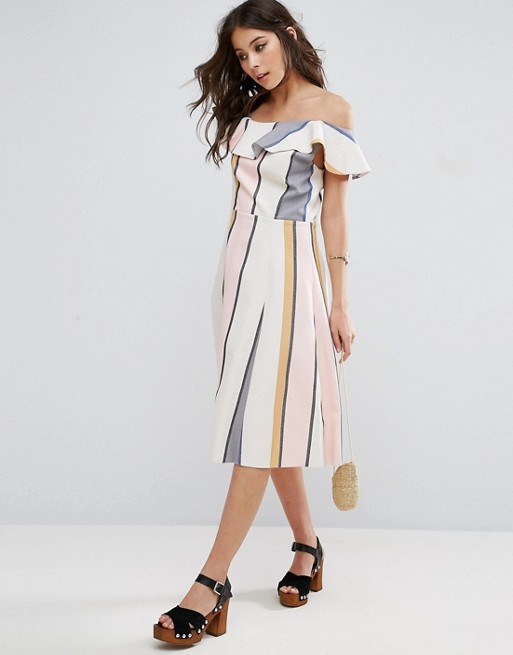 This dress is one of our absolute favorites! The candy-coated appearance of the pastel stripes give an unexpected element to our favorite basic pattern. We would love to see this dress with a luxurious velvet bootie and a lacy choker to draw attention to the neckline. 