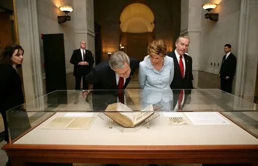 President George W. Bush and Laura Bush tour the National Archives in Washington, D.C., Wednesday, Jan. 19, 2005 viewing the George Washington Inaugural Bible used by both Washington and his father, George H. W. Bush.