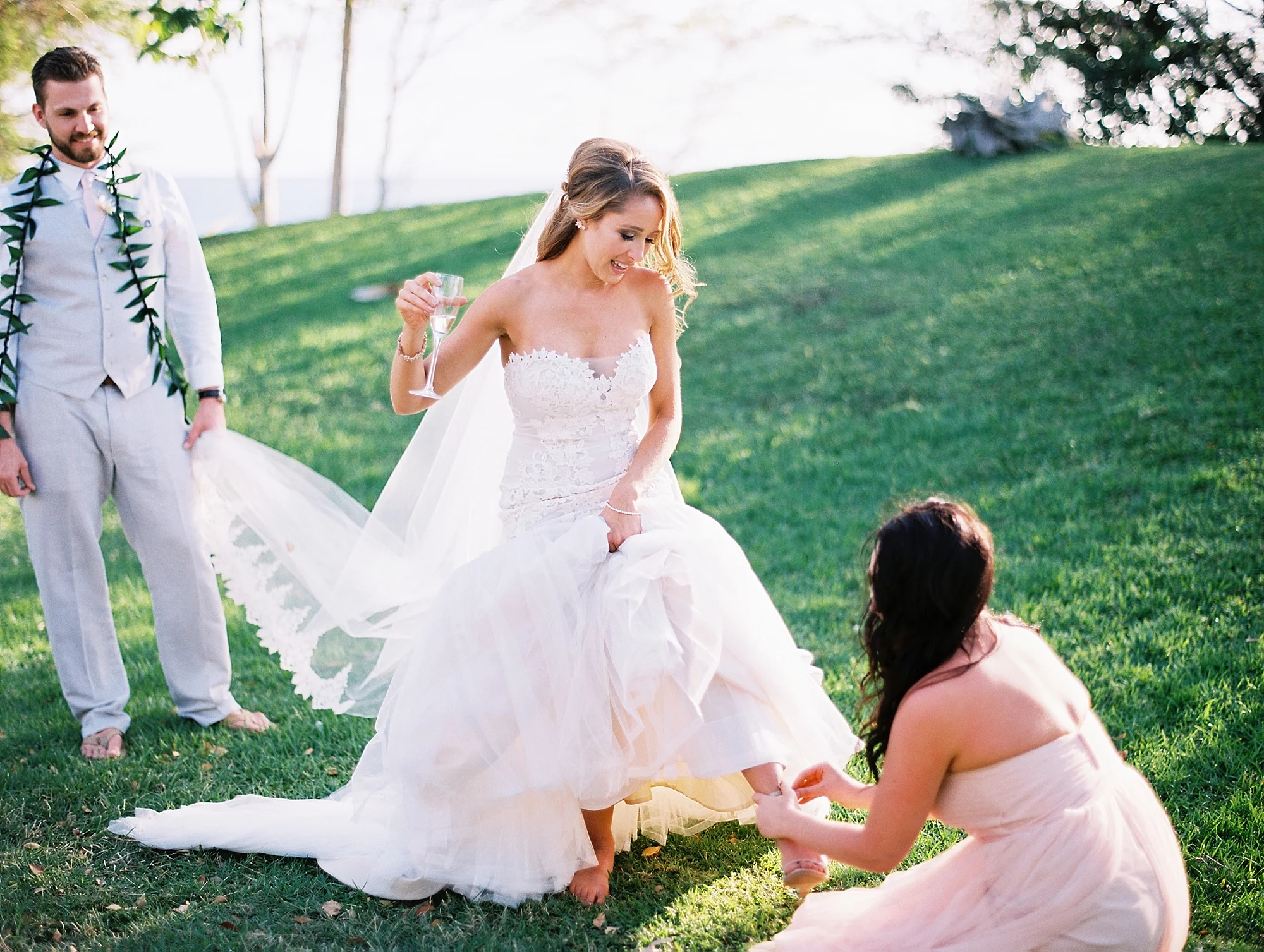 26-bride-groom-maid-of-honor-fixing-shoe.jpg