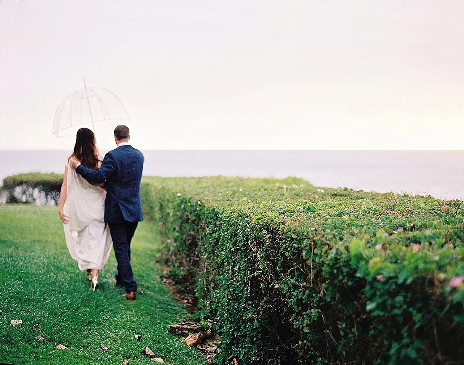 romantic-rainy-maui-wedding-merrimans-kapalua-bride-groom-walking-umbrella