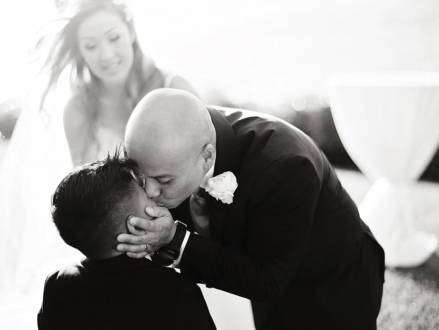 sweet-father-son-kiss-maui-wedding-moment-black-and-white