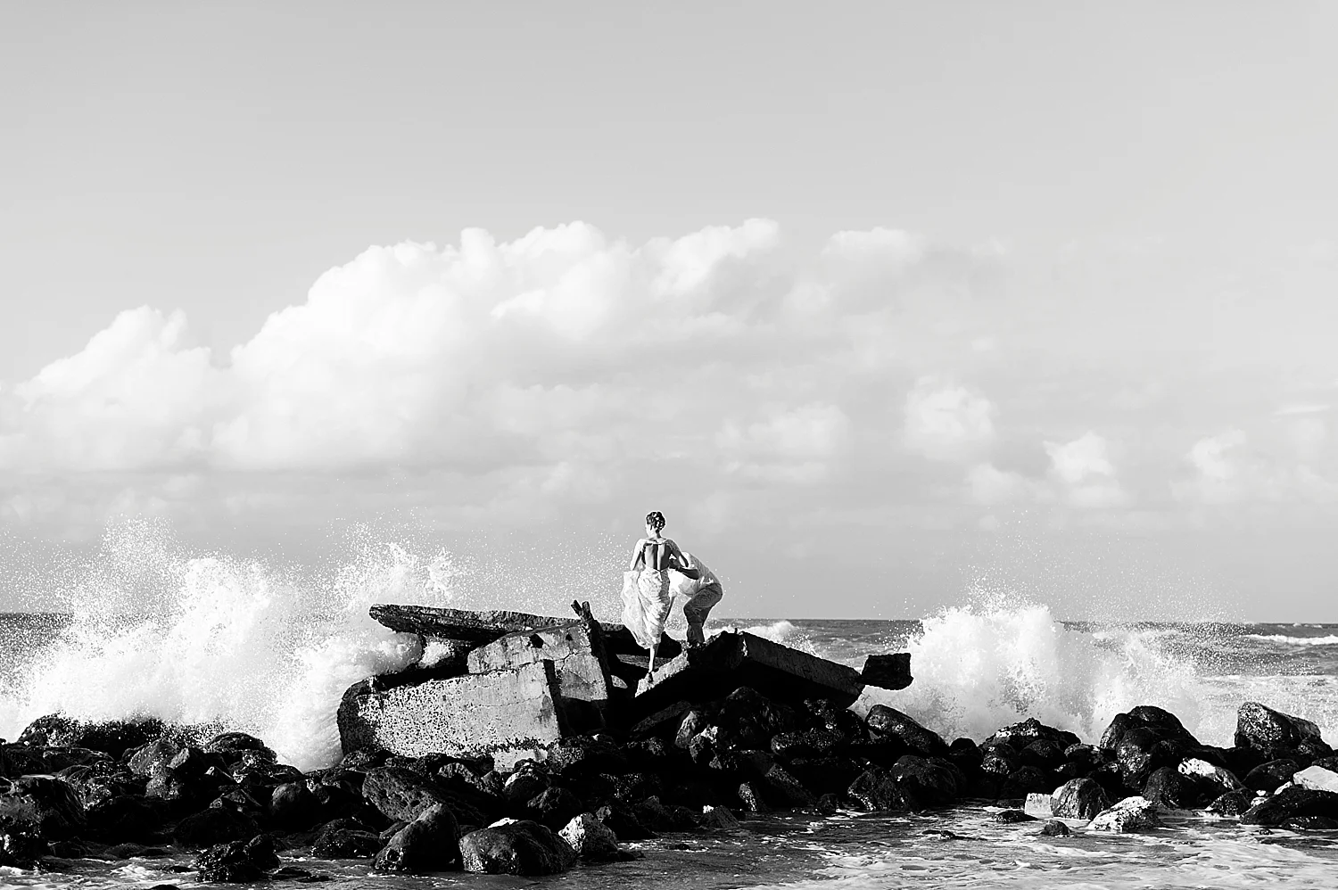 maui-bride-and-groom-walking-amongst-rocks-beach-wedding-black-and-white