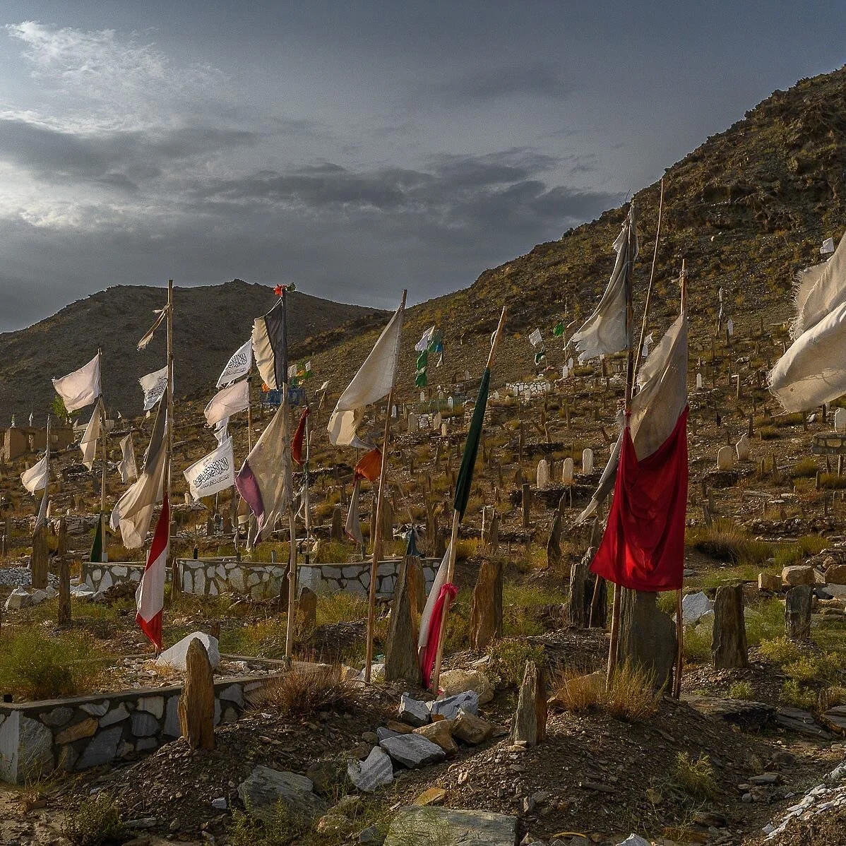 In Burhani Khel&rsquo;s cemetery, flags marking civilian graves stand alongside those of Taliban fighters. Located in a remote part of Wardak's Sayed Abad district, the village has been the theater of some of the war&rsquo;s most violent episodes. It
