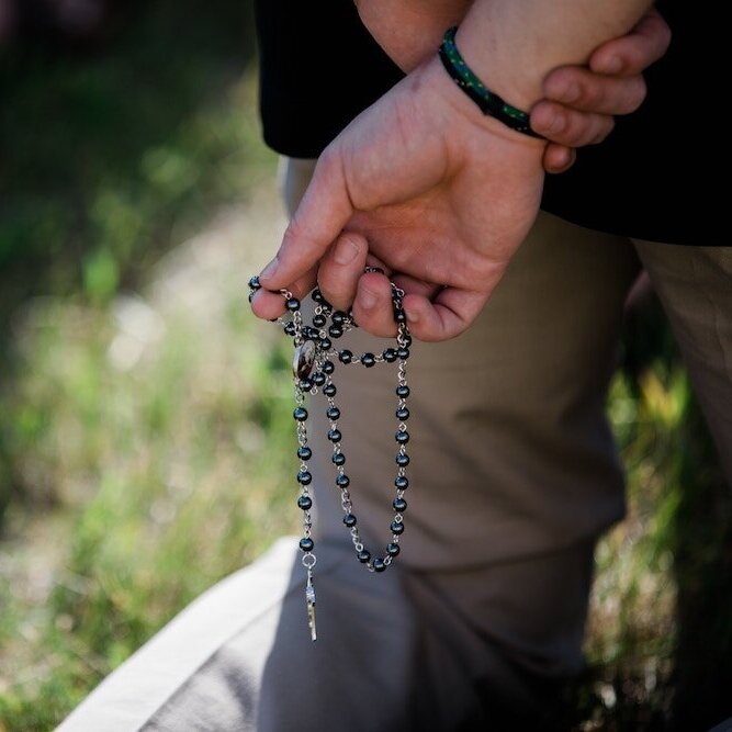 Man holding Rosary