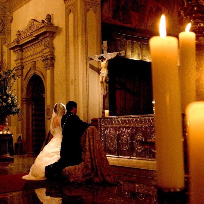 Bride and Groom Kneeling before Crucifix