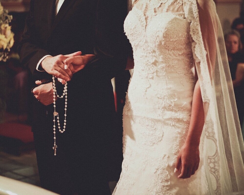 Bride and Groom Holding Rosary during Wedding