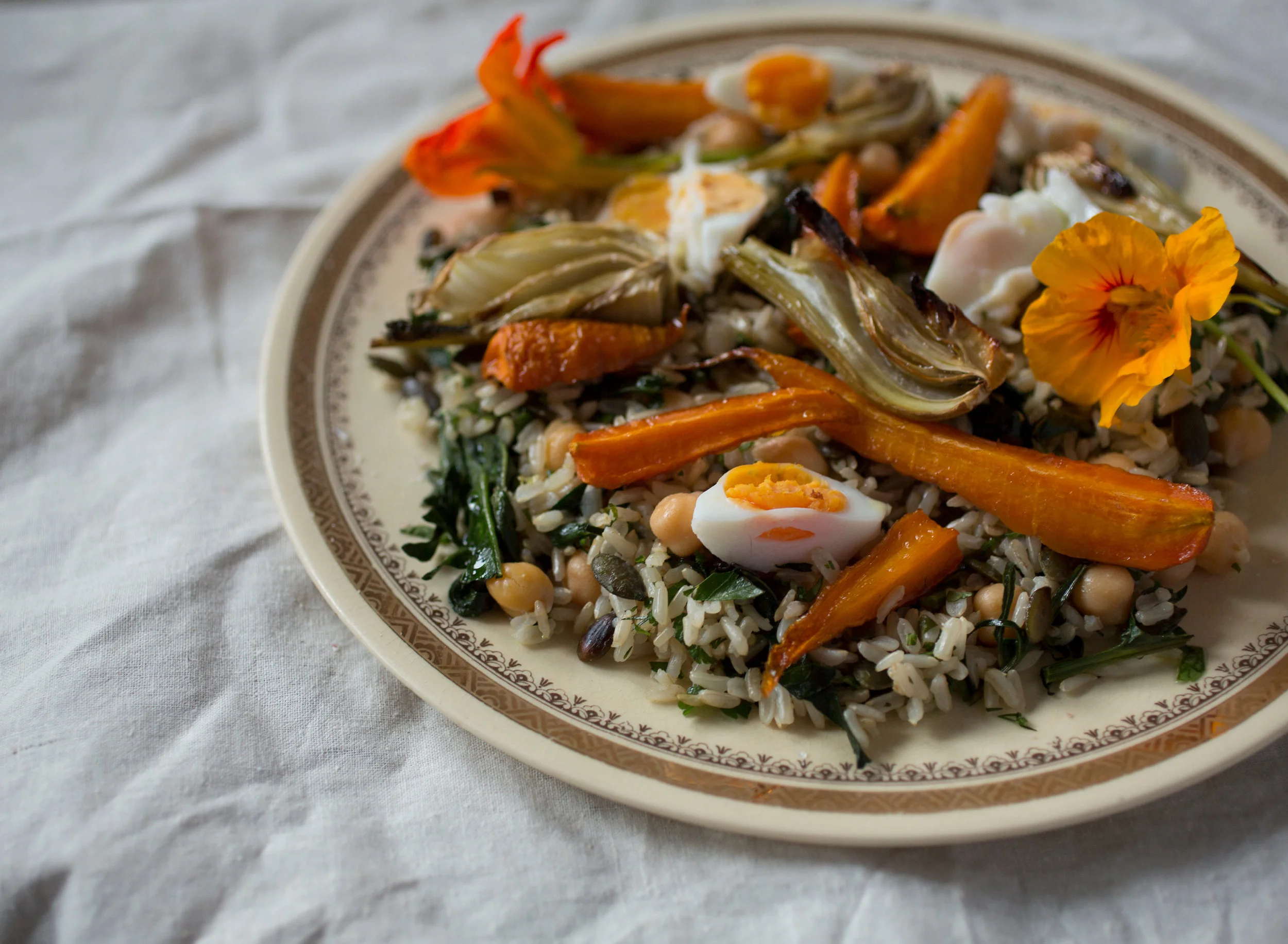 Variation 1 - roasted carrots and fennel topped with poached eggs and nasturtiums.