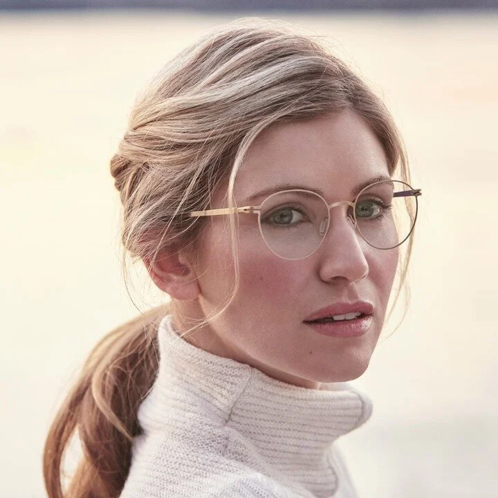 Model wearing thin-rimmed designer eyeglass frames available at iCare Family Vision in St. Louis Park