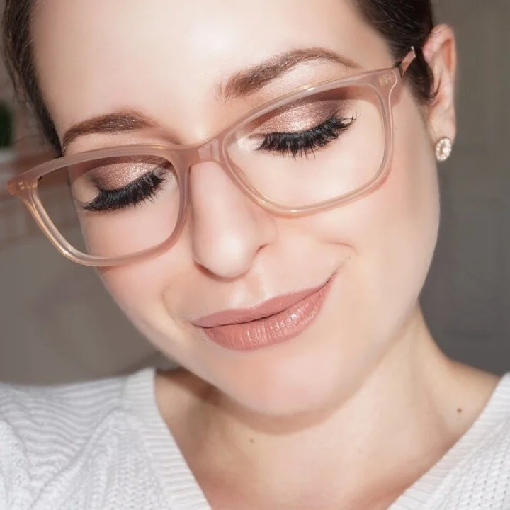 Model wearing handcrafted frames from the iCare Family Vision optical boutique in St. Louis Park