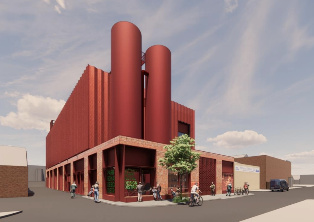 Impression of the new Minerva Road Energy Centre. A red industrial modern building with circular pipes and corrugated walls.