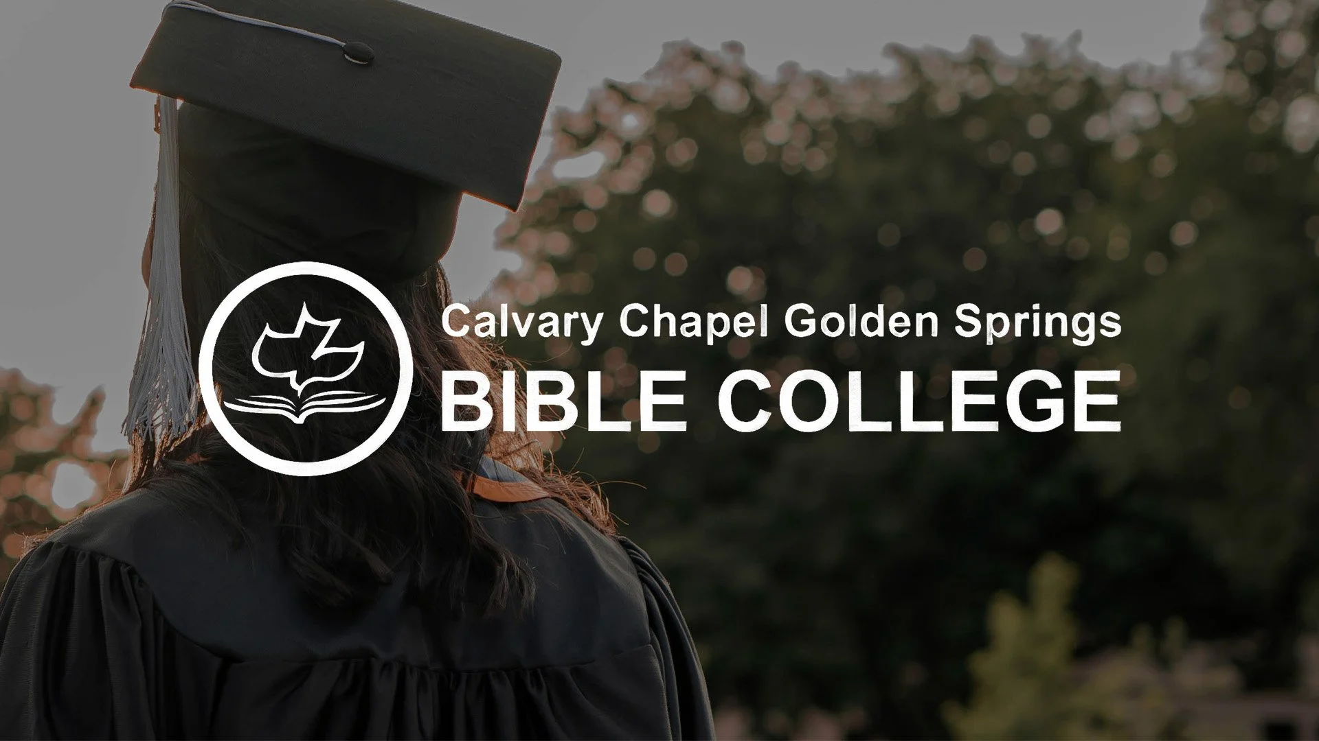 A woman in a graduation cap and gown stands outdoors in front of trees with pink blossoms. Overlaid on the image is text that reads, "Calvary Chapel Golden Springs Bible College" with a logo of an open book and a leaf beside it.