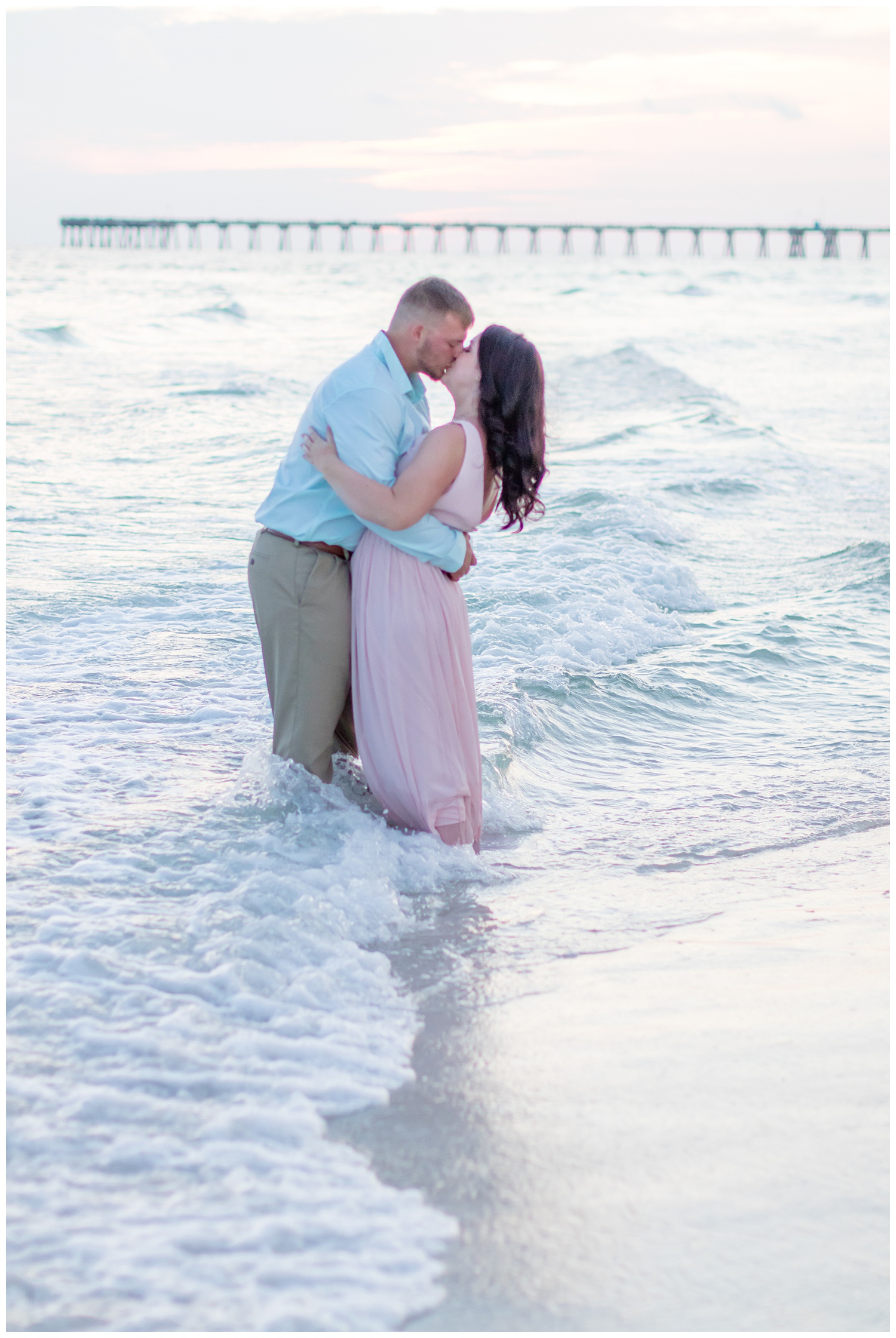 kissing in the ocean waves in PCB Florida Panama City Beach
