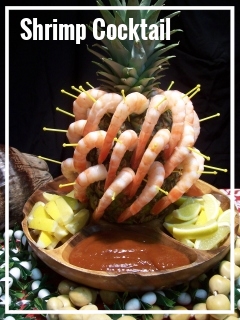 SHRIMP ON PINEAPPLE DISPLAY Medium sized, fully cooked shrimp and individually arranged on a full pineapple with cocktail sauce and lemon slices. A beautiful addition for tropical buffets or use as table centerpieces. Each arrangement contains 40 shrimp. Each Arrangement, $90