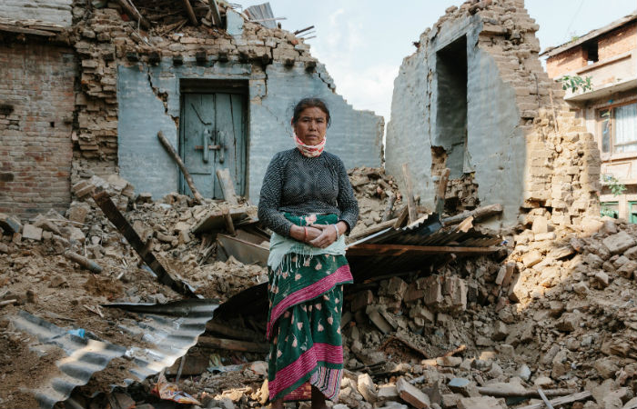 Nepalese women standing outside of her home