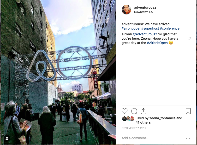 Trina in front of the Airbnb Open sign in Downtown LA.