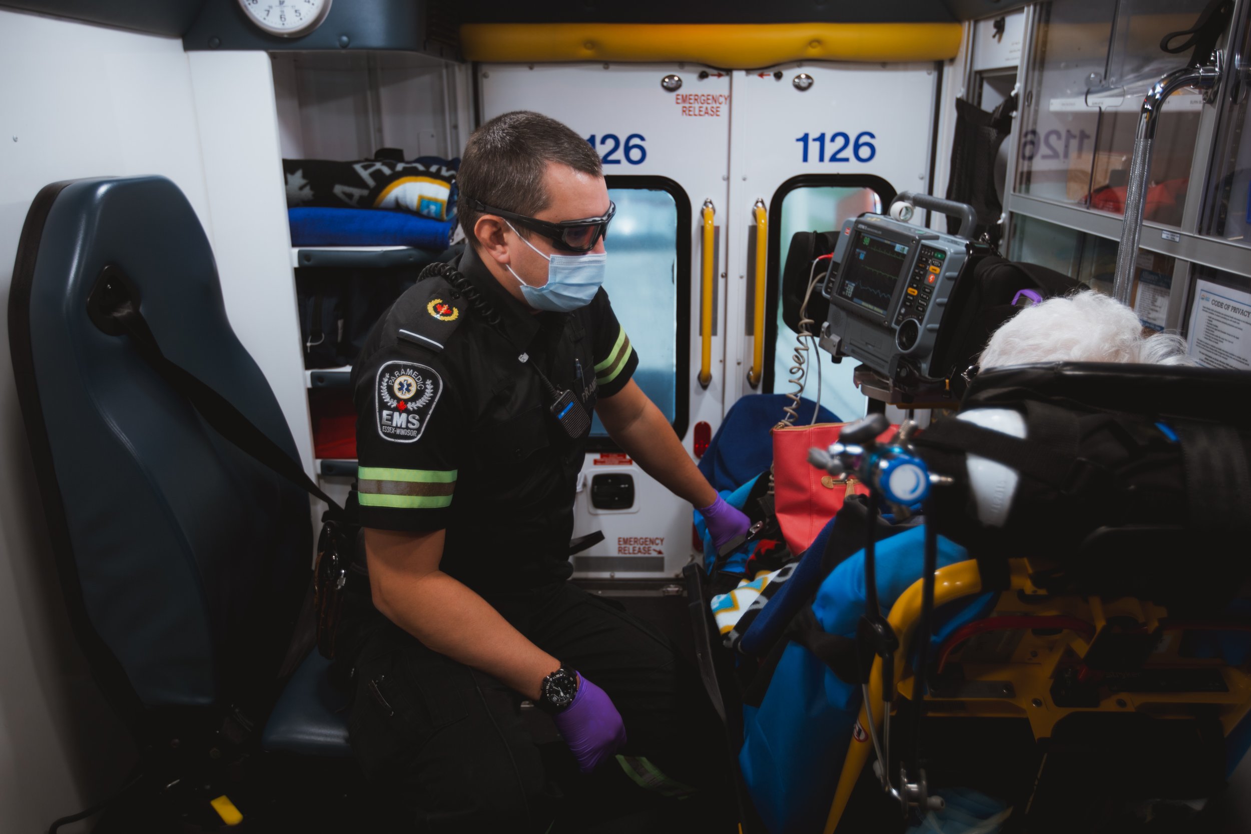  EMS Paramedic, Nick Jovanovic, speaks to a woman being transported to the hospital after having a fall at her home (for the Windsor Star, 2021). 
