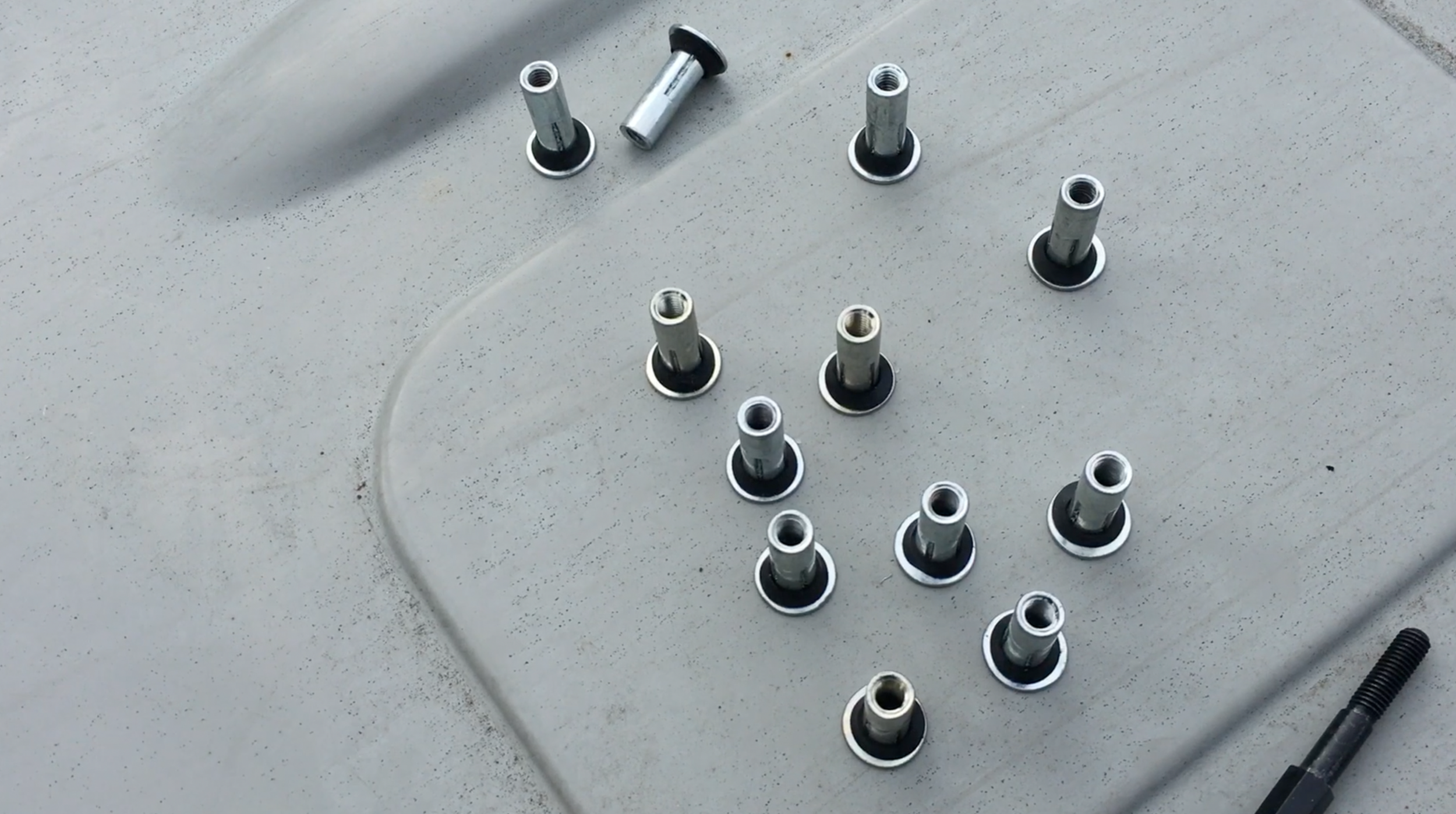 Funny shaped plus nuts go in the holes you drilled to secure the tracks down