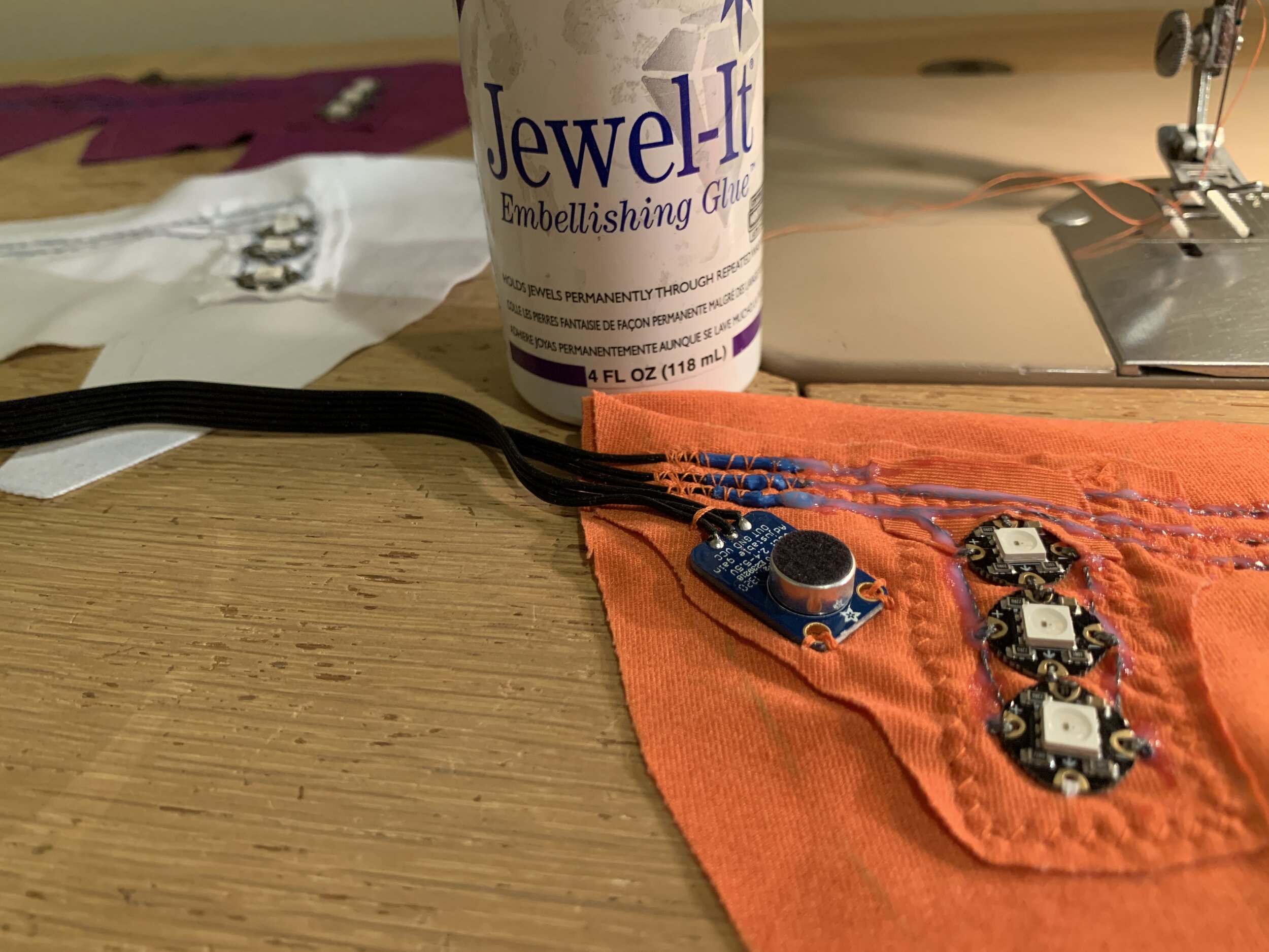 I used Jewel-It glue to secure and insulate the conductive threads