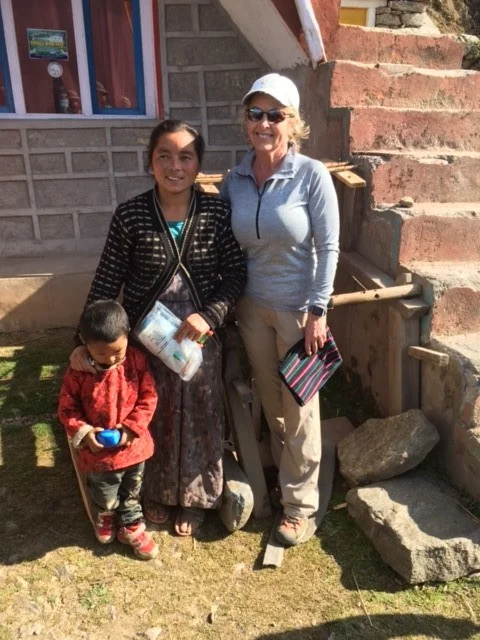 A Red Panda trekker with a local woman in Sherpa Gaun.