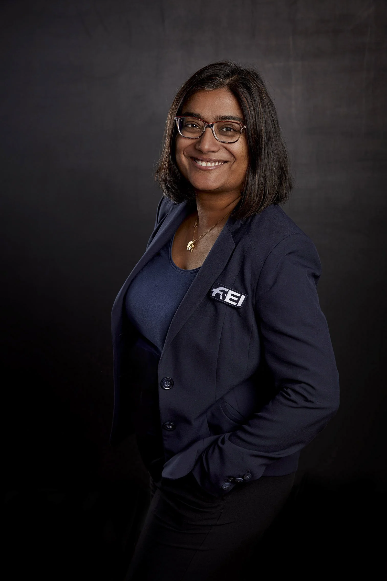 Business portrait taken on a black textured background