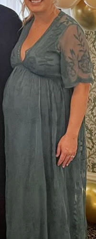 This dress is the same as the off-white dress in the previous photo. The color is a teal blue/green