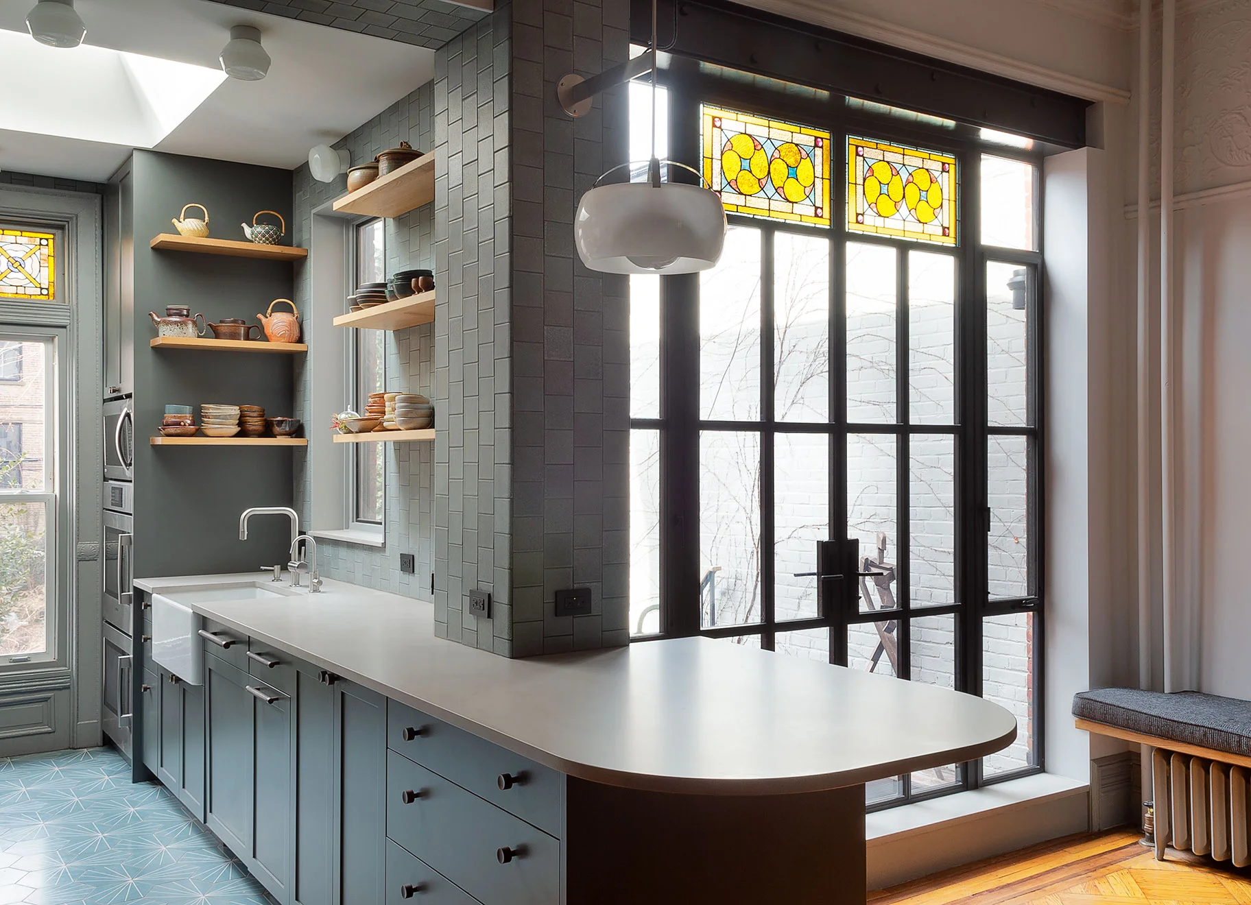 Doors and Passages This venerable, Park Slope, Brooklyn, brownstone had numerous original details, many of which the owners wanted to keep. However, they wanted to mix in a modern sensibility, in a respectful way, while optimizing the house for their lifestyle. This included opening the kitchen to the dining room, adding a rear glass wall, deck, and secret powder room.