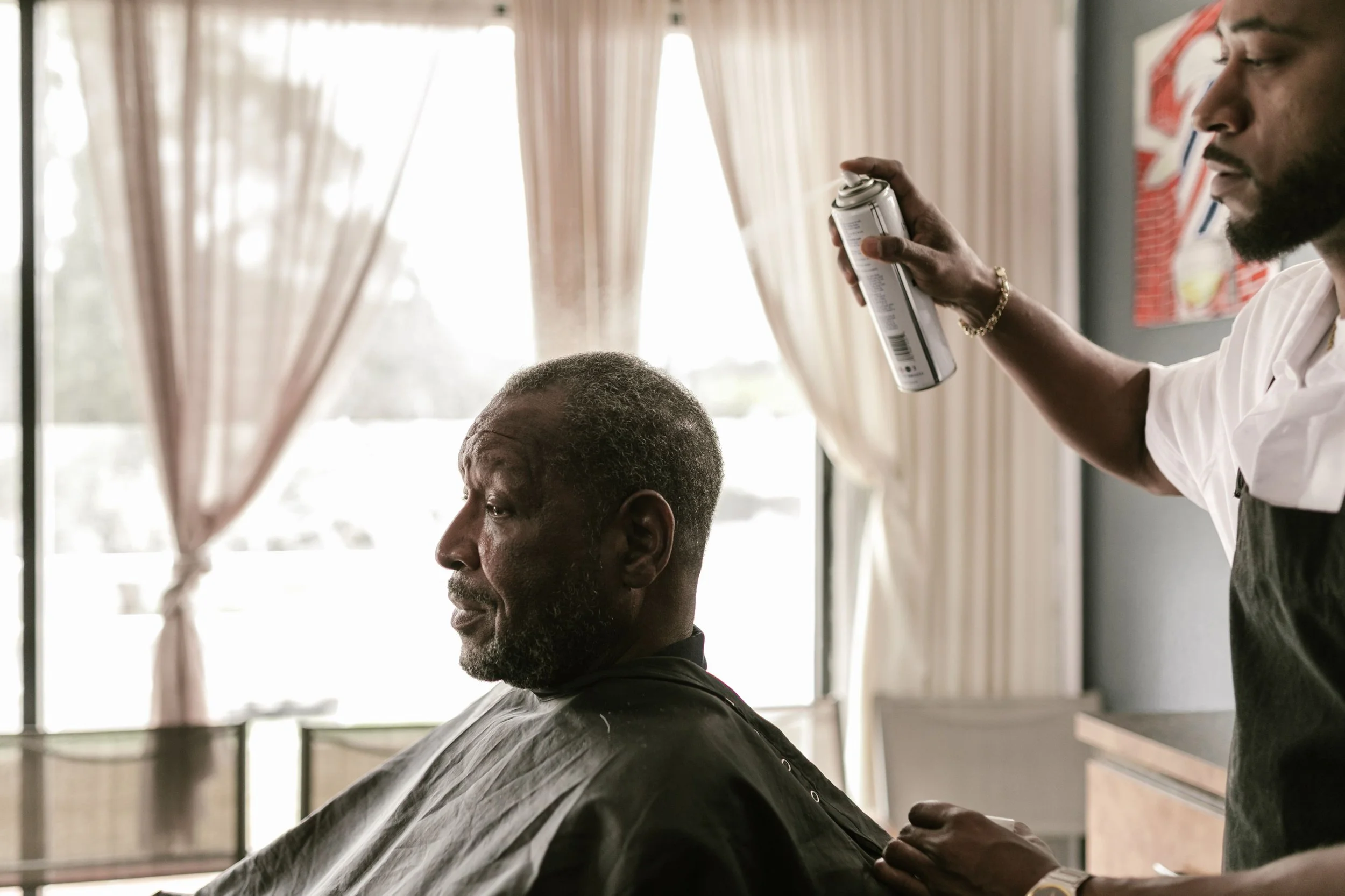 barbers using alcohol spray  after a haircut