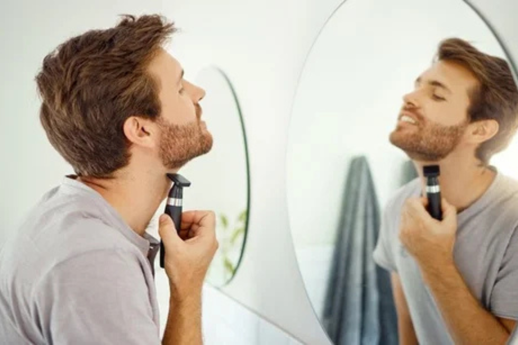 Man Using Shaving Cream with an Electric Razor