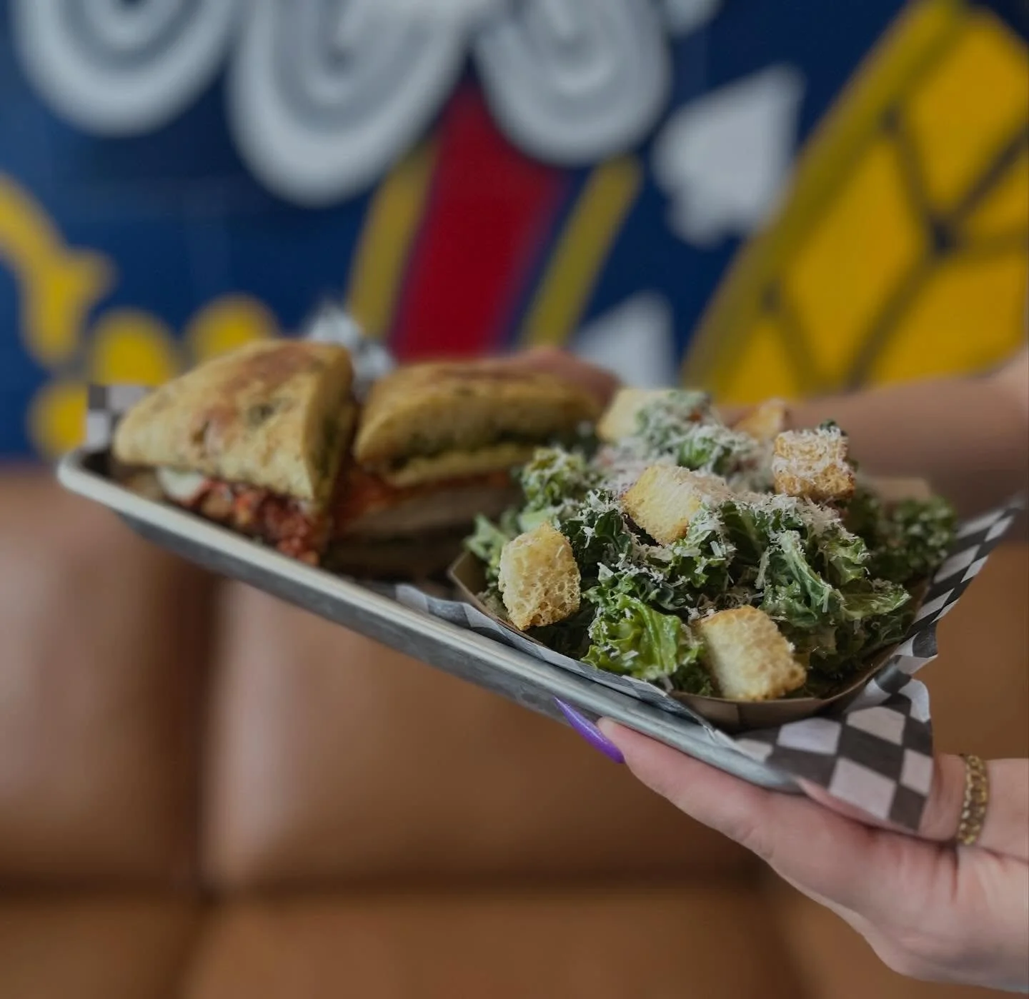 🥪 Have you tried our NEW Chicken Parm yet with a side of Kale Caesar? 🤤 
This sandwich has it all! 
Focaccia bun, basil pesto, marinara sauce, breaded chicken, fresh Mozza, arugula, and onions! 
Come down to Railyard Brewing and let us know what yo