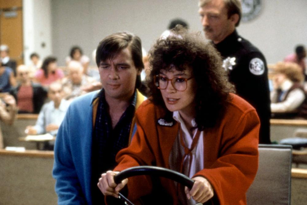 Don't let the Sally Jesse glasses and unflattering perm fool you: that's Academy Award-nominated thespian Jennifer Tilly as the romantic lead