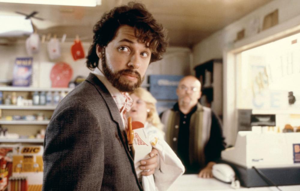 No, that’s not Oscar Isaac! It’s a disconcertingly hunky Jon Cryer