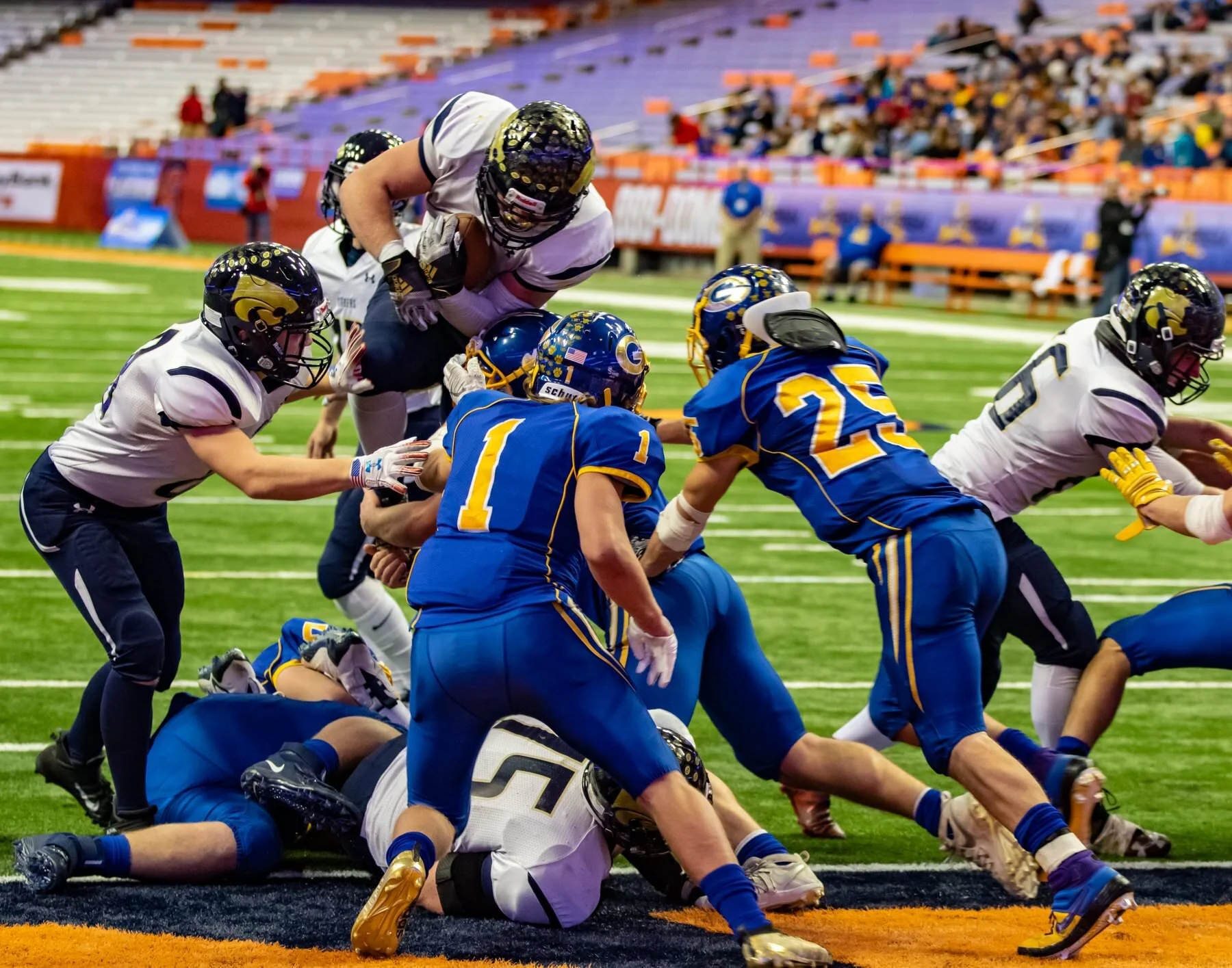 Susquehanna Valley senior Mitchell Knapp leaps over a wall of Gouverneur defenders to score a touchdown on the way to a second straight Class C State Football Championship at the Carrier Dome. (Canon 7D Mk II, 70-200 2.8L, 1/500 sec at F / 3.2, ISO …
