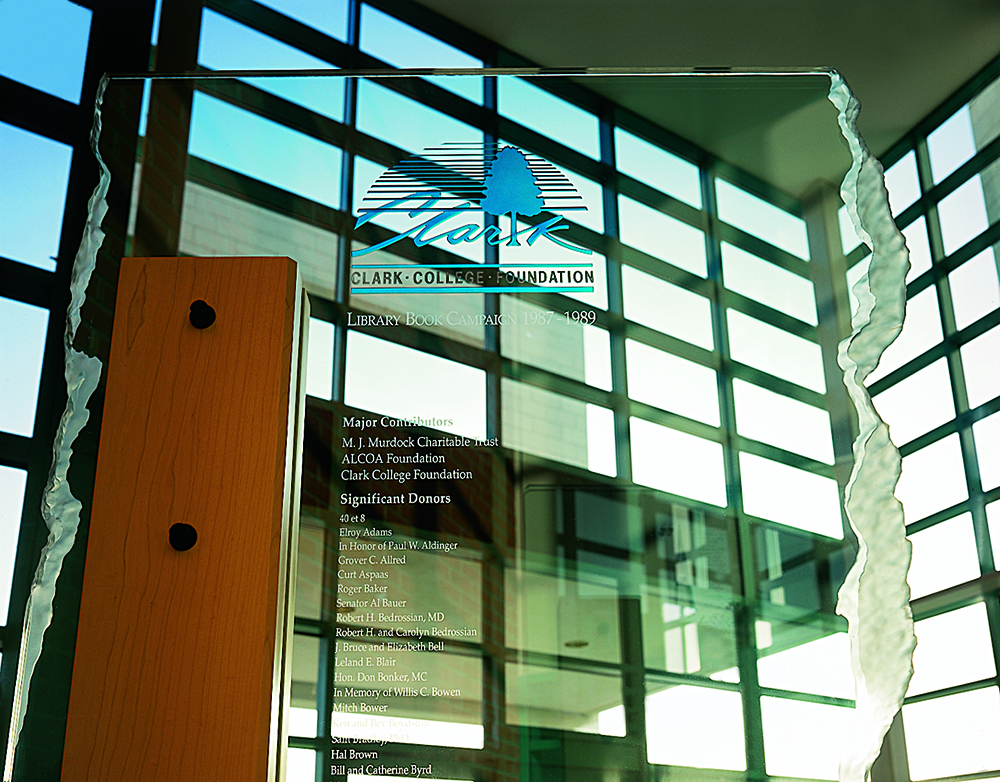 The 10'-0" tall glass, clear grain Douglas Fir, and steel water jet cut bases. The freestanding donor blades mirror a lobby sculpture by a regional artist. Edges were sandblasted by hand to create a unique edge condition, donor names were photo etch