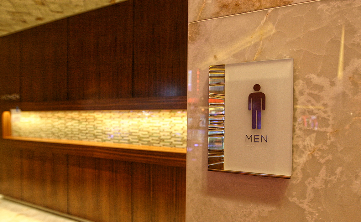 Etched brass and glass ADA plaques formed the primary palette used in the public gaming areas of the casino.
