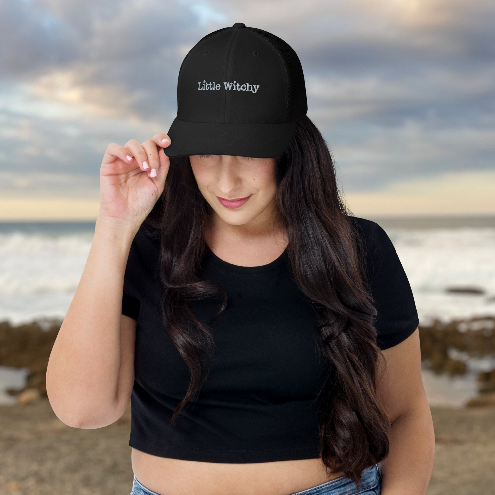 Woman wearing Little Witchy trucker hat along the California Coast