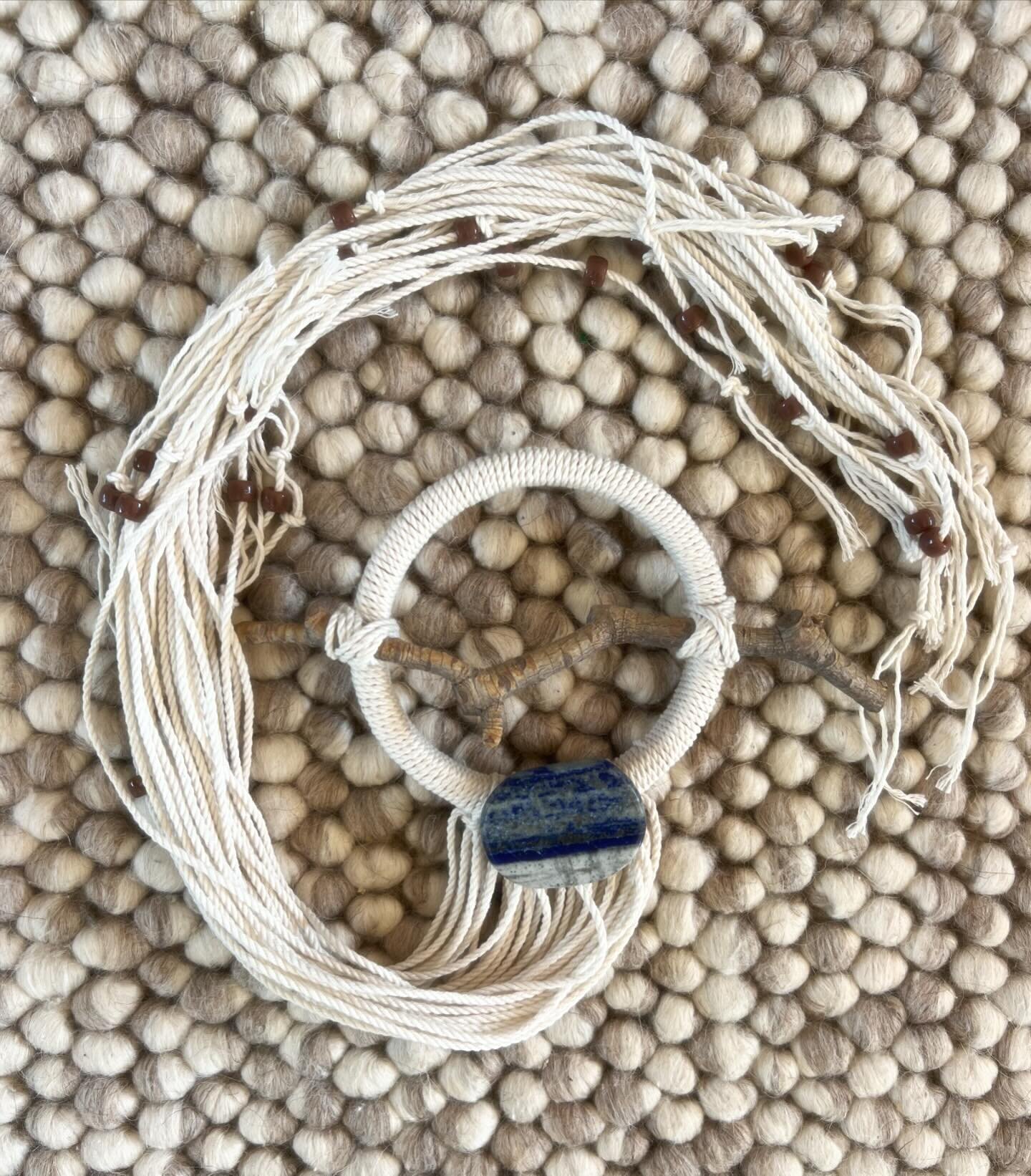 POPPY on rug. 

X-Small (4&rdquo; diameter) wall hanging in off-white rope, with grey/brown beads.

Stones: Lapis Lazuli

Meaning: Lapis Lazuli is the symbol of royalty and honor, gods and power, spirit and vision. It is a powerful crystal for activa