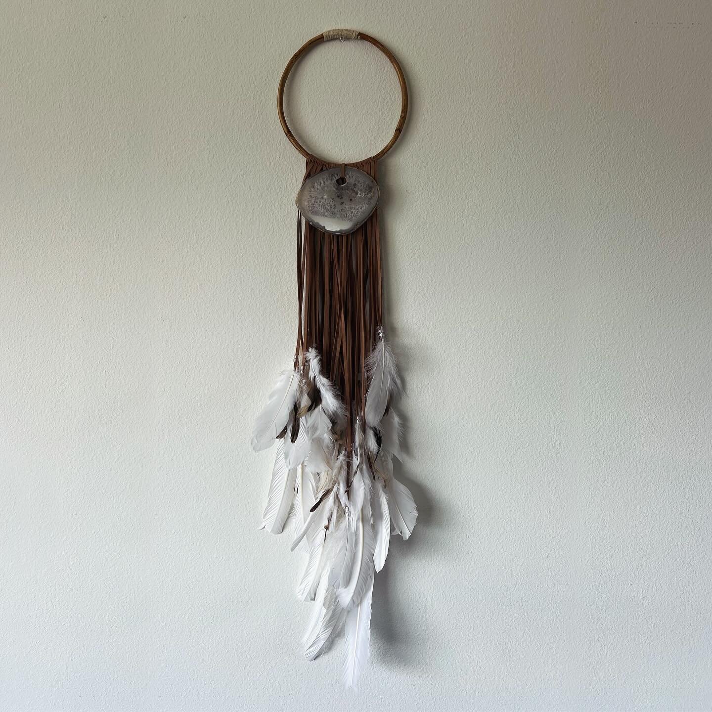 (New!)
CLAUDIA. Medium (8&rdquo; diameter) wall hanging on a wood circle with  tan faux suede cord, layered white with white and multi-colored brown feathers, clear beads and agate center. 

DM me if interested or check site to purchase!

#wallhangin