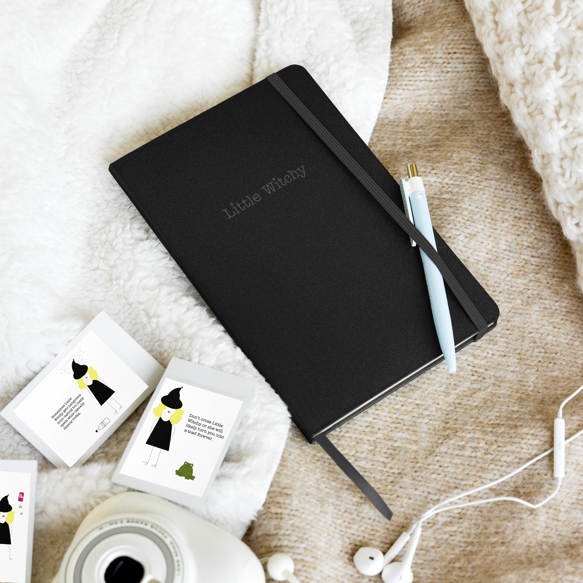 Little Witchy black journal on blanket with little witchy cards nearby