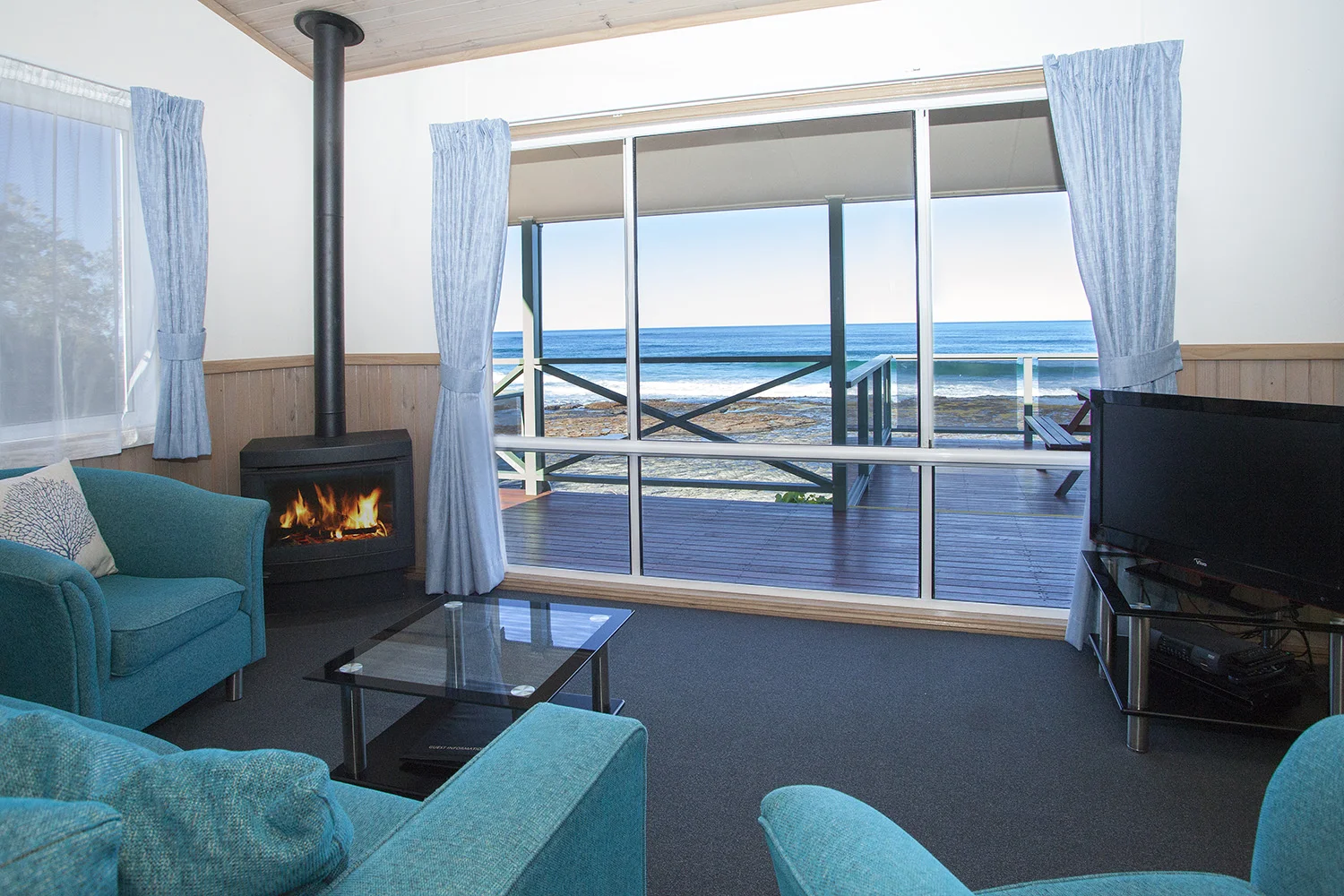 Oceanfront Deluxe, Chalet 11 living room with fire copy.jpg