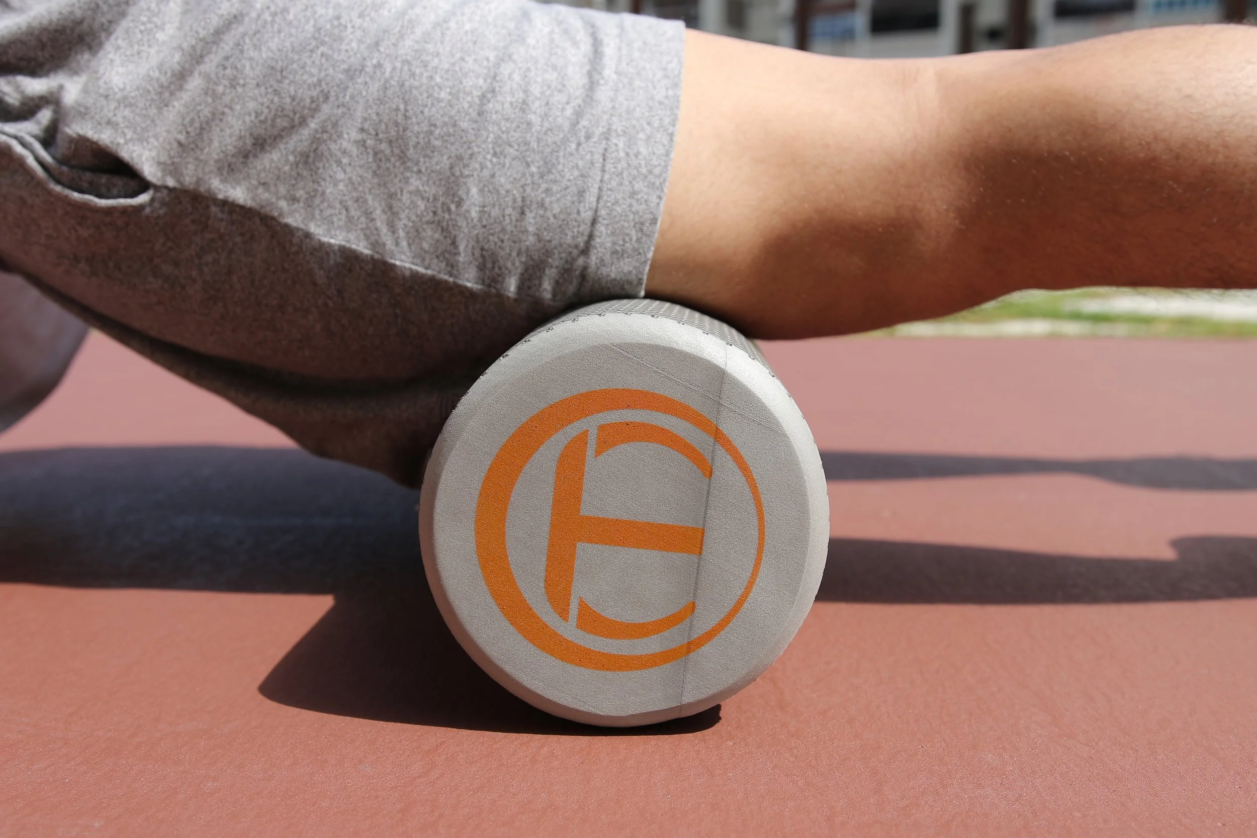Image shows quadricep foam rolling with a regular foam roller