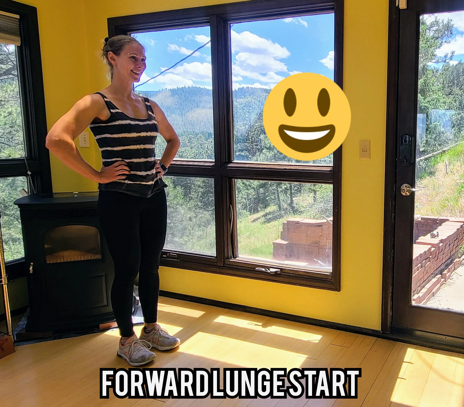 Robyn Fog is standing on two feet with hands on hips in a "ready" position for a forward lunge.