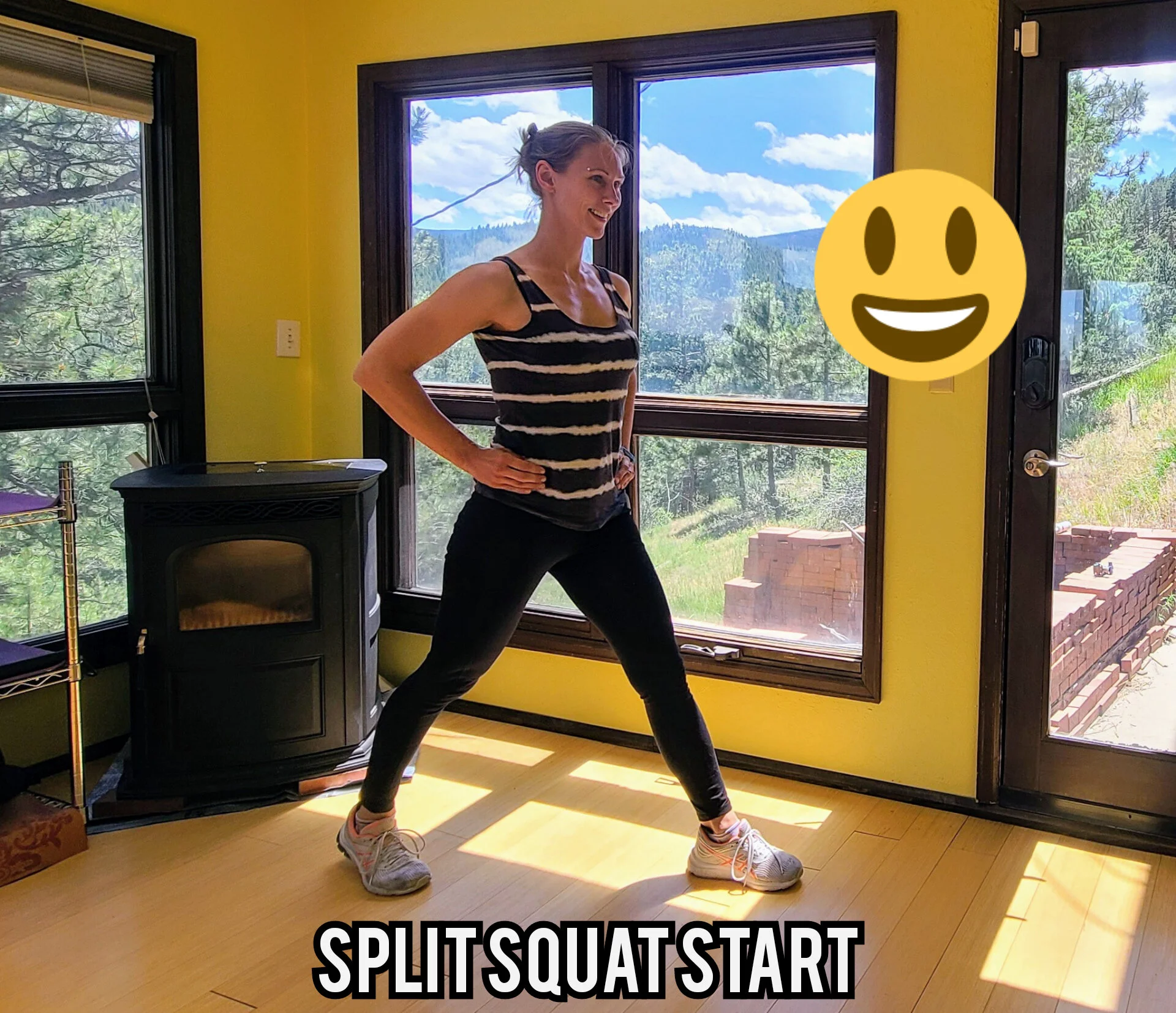 Robyn Fog is showing split squat starting position with legs split apart, one in front of the other. The back heel is slightly lifted.