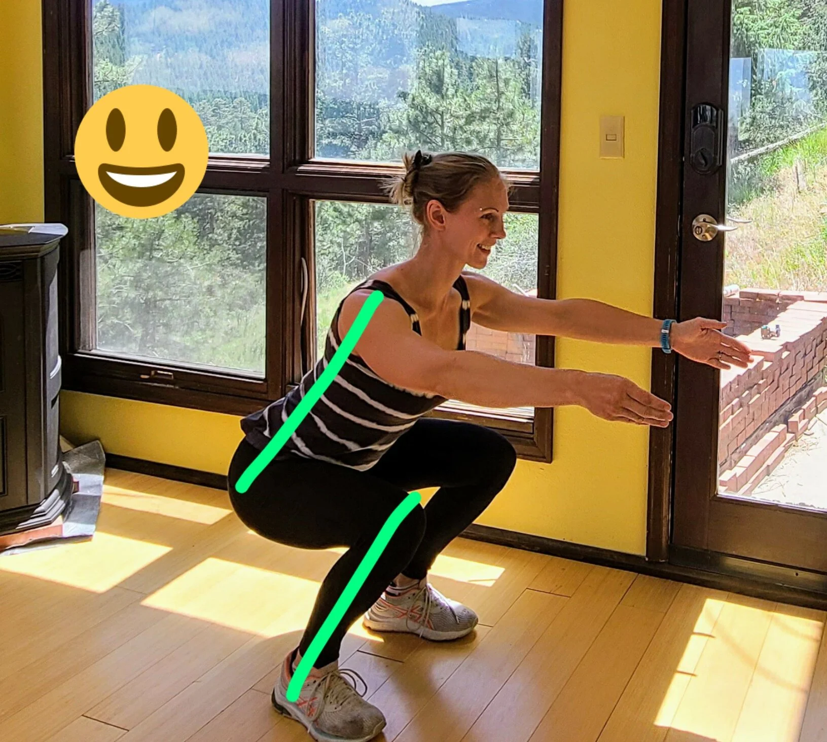 Picture shows Robyn Fog at the bottom of a deep squat. Her torso and shins are highlighted with parallel green lines to show proper body alignment.